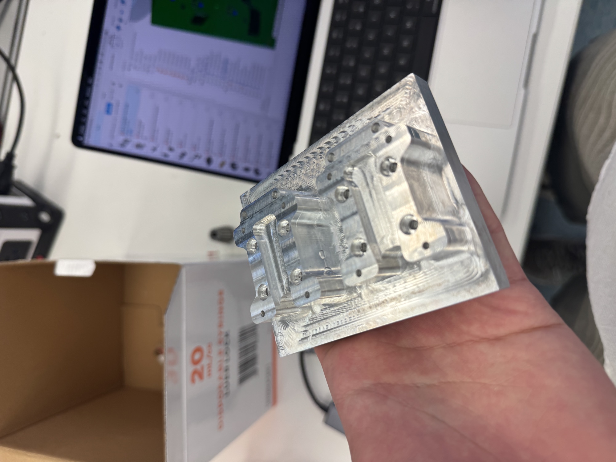 Machined 6061 aluminum carriage, held in hand